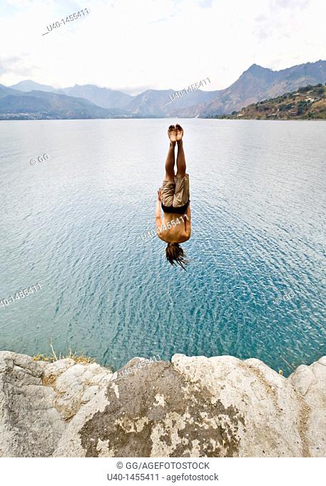 Guatemala, San Marcos La Laguna, man jumping off cliff