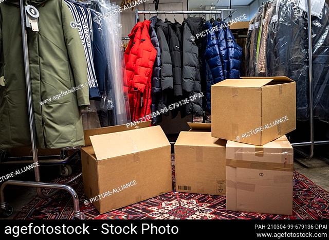 02 March 2021, Bremen: Winter clothing sits in a fashion store's warehouse. Spring is coming, but fashion and shoe stores up north are still sitting on the...