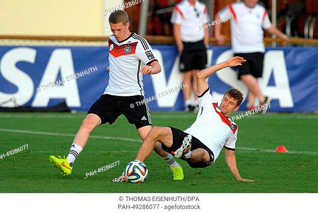 Thomas Mueller (r) and Matthias Ginter in action during a training session of the German national soccer team at the training center in Santo Andre, Brazil