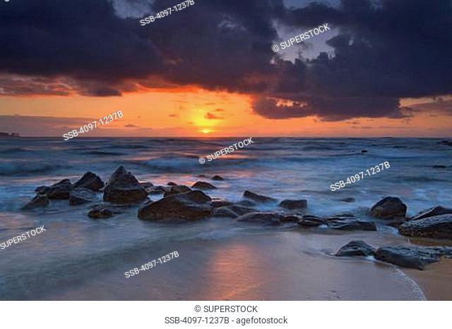 Rocks on the beach at sunrise, Coconut Coast, Kauai, Hawaii, USA