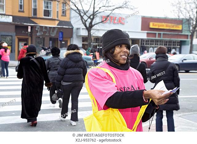 Washington, DC - A volunteer from The Women's Collective distributes condoms and AIDS prevention information on a busy street corner