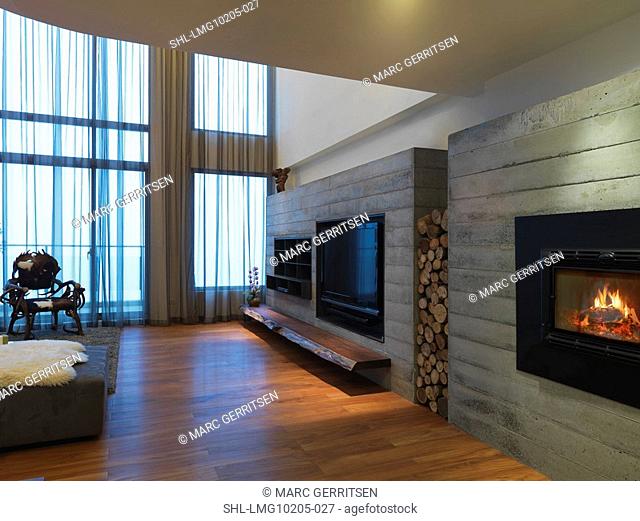 Television and fireplace built in to wall in modern home