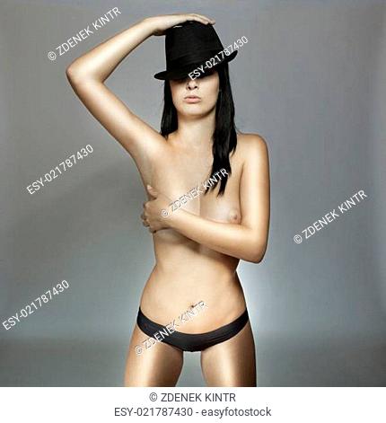 glamour young beautiful girl in black panties with hat