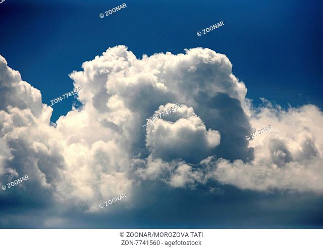 The image of white clouds on a background of the dark blue sky