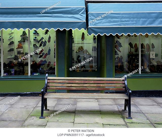 England, East Riding of Yorkshire, Bridlington. A bench outside a traditional shoe shop in the old part of Bridlington