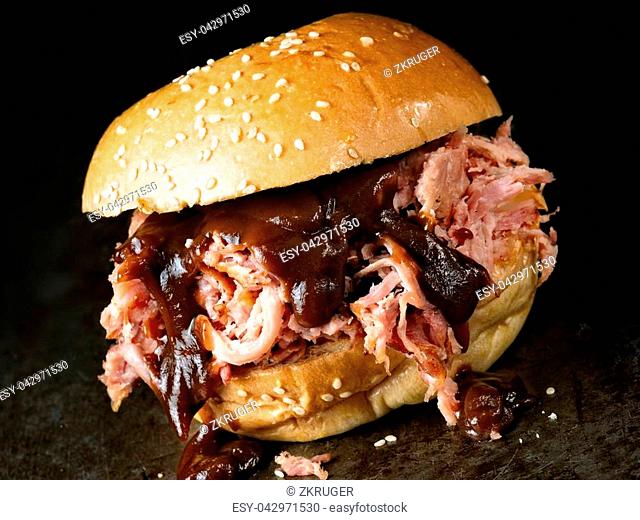 close up of rustic american barbecued pulled pork sandwich