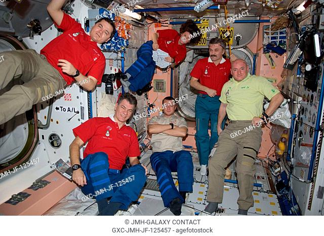 Expedition 26 crew members are pictured in the Unity node of the International Space Station on New Year's Eve. Clockwise from the left are Russian cosmonaut...