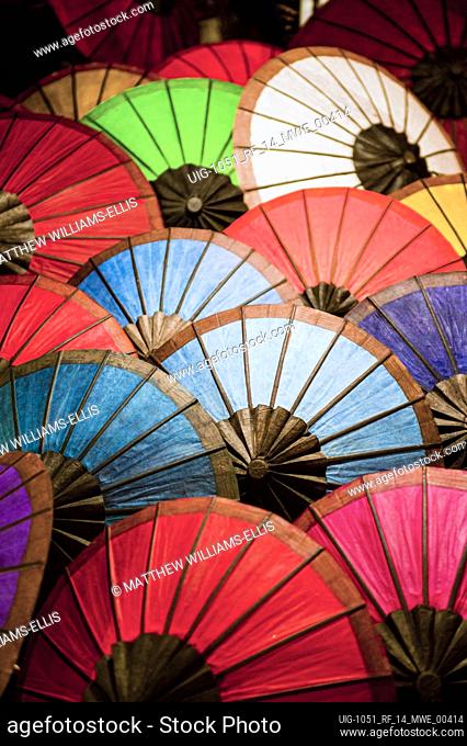 Colourful umbrellas for sale at market stalls at the night market in Luang Prabang, Laos NB: This photo contains some levels of noise