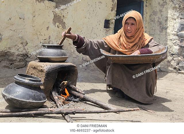 Muslim woman cooking on an earthen stove in a small village in Kargil, Ladakh, Jammu and Kashmir, India. (This image has a signed model release)