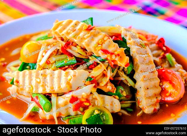 Som Tam Vietnamese Pork Sausage (Spicy Papaya Salad) with salted crab, on wooden table ( Thai food)
