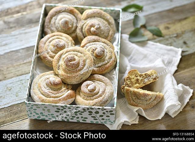 Vegan yeast dough buns with an almond filling and icing sugar in a gift box