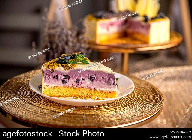 Piece of blueberry cheesecake on the plate at coffee shop