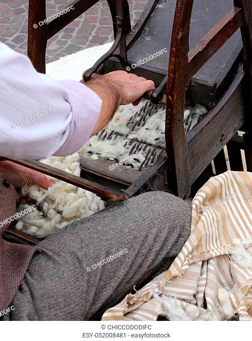 Elder carder while carding wool or cotton with old wooden machine to make the cushions and mattresses