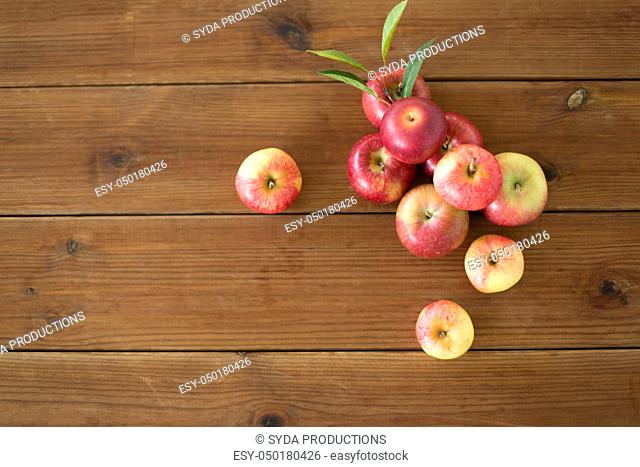ripe red apples on wooden table