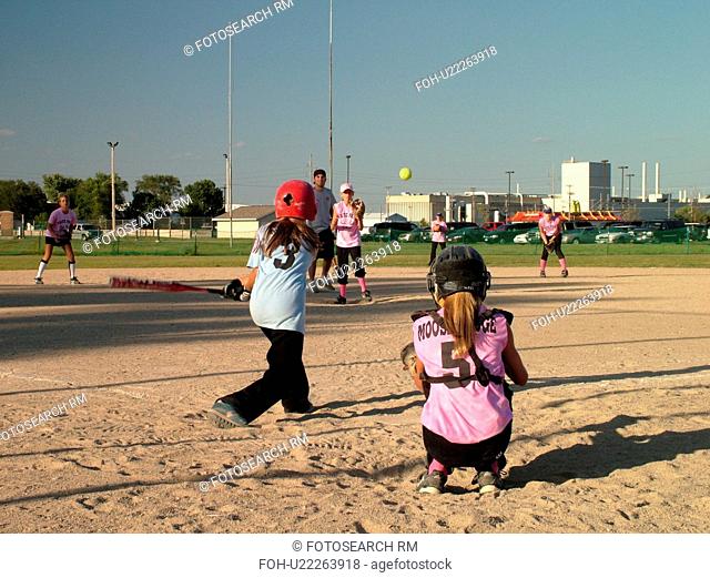 St. Joseph, MN, Minnesota, Girls Babe Ruth Softball Game, Little League, Baseball, batter swings at ball, pitcher throws the ball