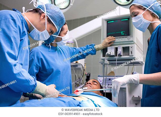 Doctors operating a patient in operating theater
