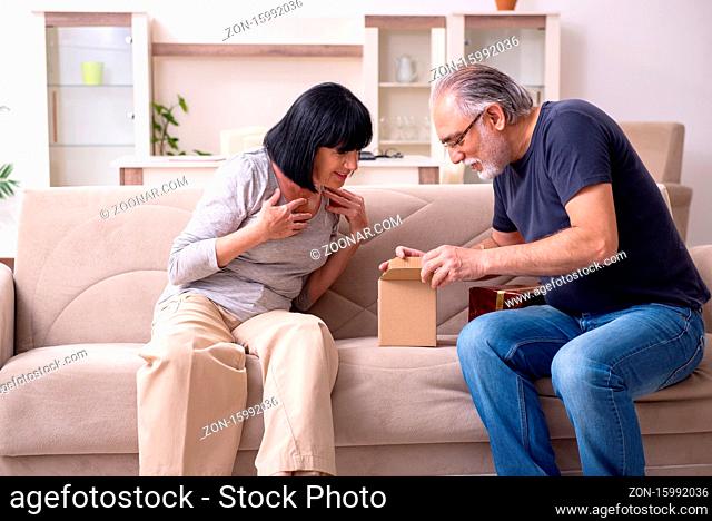 Old couple doing the online shopping at house