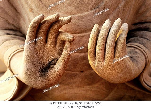 Details of a Buddha statue's hands in a temple in a village near Battambang, Cambodia