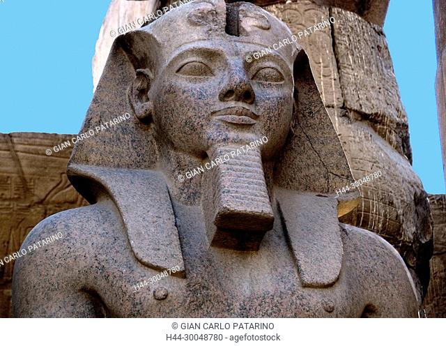 Luxor, Egypt. Temple of Luxor (Ipet resyt): a close-up of a big statue of the king Ramses II (1303-1212 b.C.)