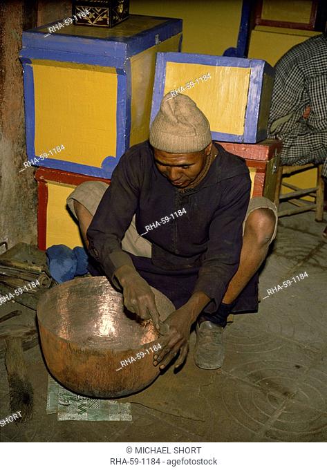 Coppersmith working on bowl, Marrakesh Marrakech, Morocco, North Africa, Africa