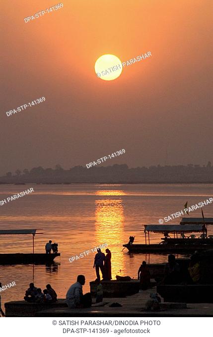 Sunset on river Narmada at the bank of Maheshwar ghat ; Madhya Pradesh ; India
