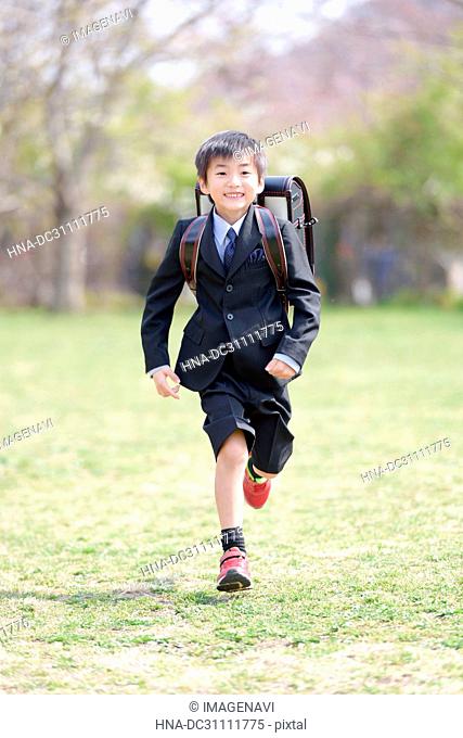 Fresh First Grade Pupil Boy Running in Park