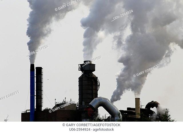 Air pollution coming from smoke stacks at a paper mill