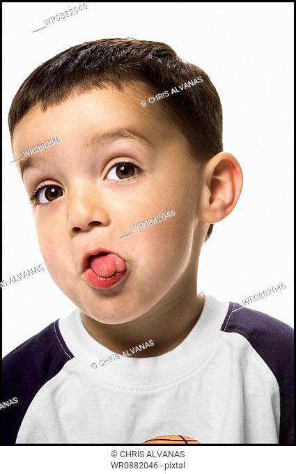 Close-up of a boy sticking out his tongue