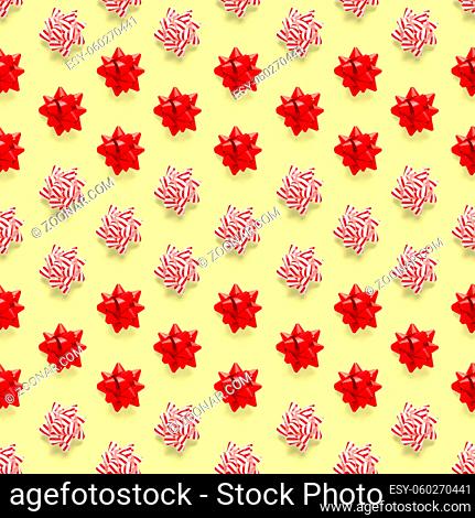 Seamless regular creative Christmas pattern with New Year decorations on yellow background. xmas Modern Seamless pattern made from christmas decorations