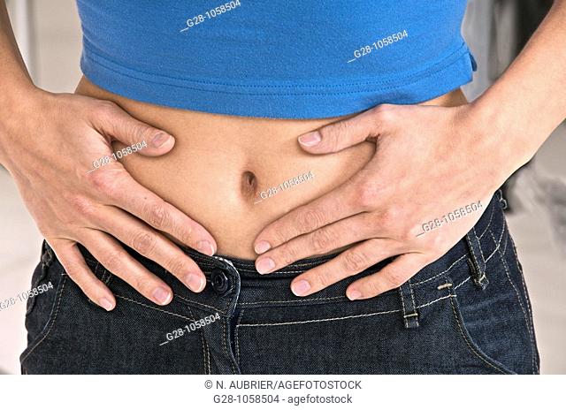 woman holding her stomach and suffering, periods or stomach pains, head invisible