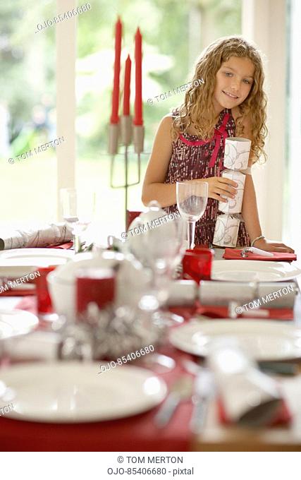 Girl setting Christmas table