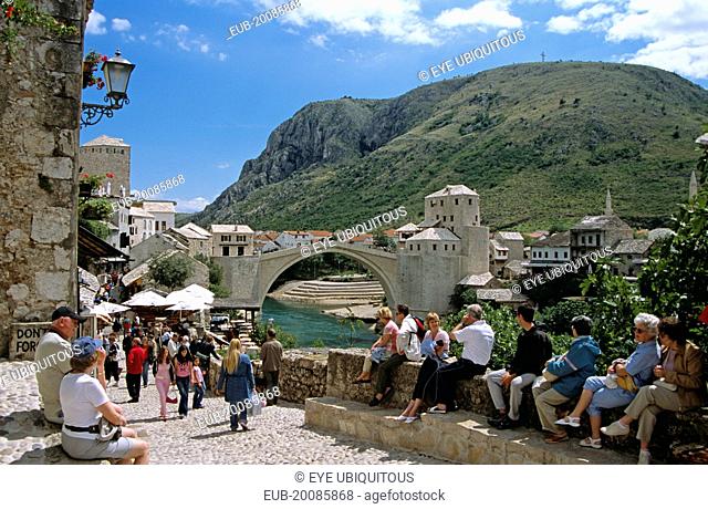 Stari Most, Old Bridge, following reconstruction, tourists, and Neretva River. Former Yugoslavia