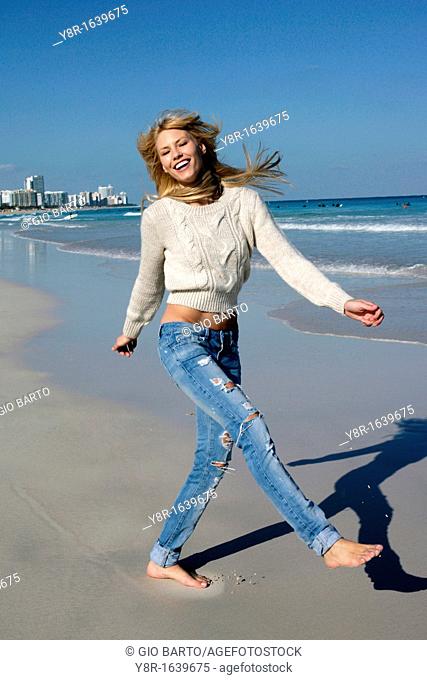 woman jumping next to seaside