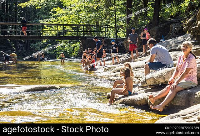 People enjoy cool water swimming in Mumlava River Waterfall, Giant Mountains, Liberec Region, Czech Republic, on Wednesday, July 20, 2022