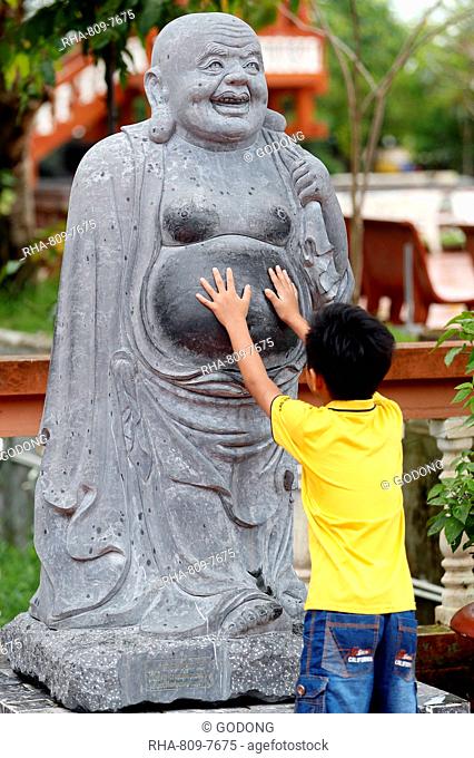 Truc Lam Phuong Nam Buddhist temple, small boy touching Angada statue, Can Tho, Vietnam, Indochina, Southeast Asia, Asia