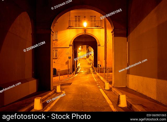 France, Nice city by night, street below buildings with arched passage in Old Town - Vieille Ville