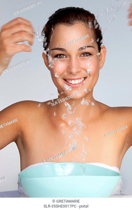 Woman splashing water