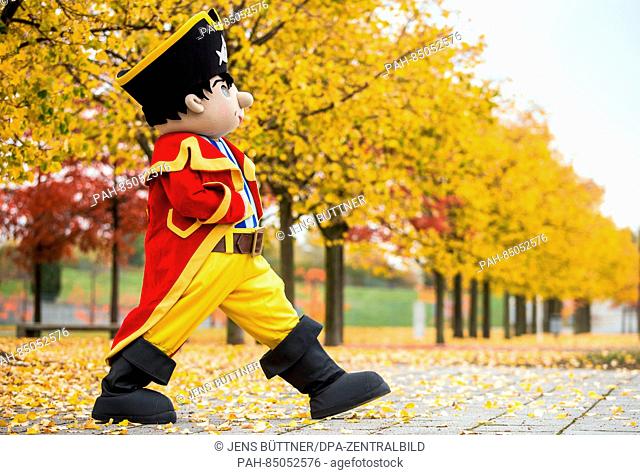 A mascot dressed as Capt'n Sharky walks through the autumnal exposition grounds in Rostock, Germany, 25 October 2016. The games