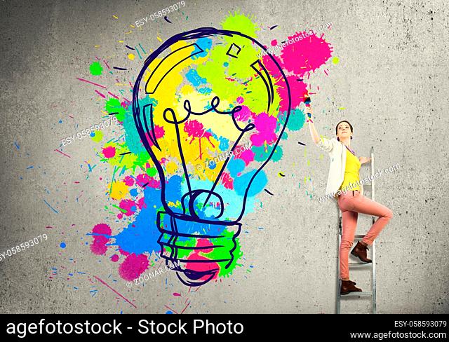 Young woman in casual drawing creativite idea concept on wall