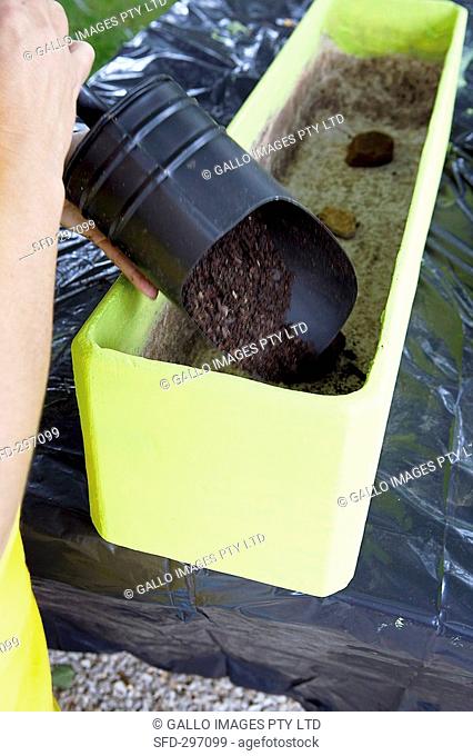 Filling a window box with soil