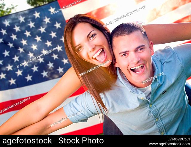 Military Couple Piggy Riding In Front of American Flag