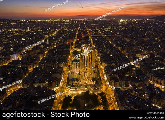Nativity Facade of the Sagrada Família and Eixample in Barcelona in the evening twilight. Aerial views (Catalonia, Spain)