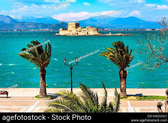 Promenade with palm trees and Bourtzi fortress in the sea in Nafplio or Nafplion, Greece, Peloponnese