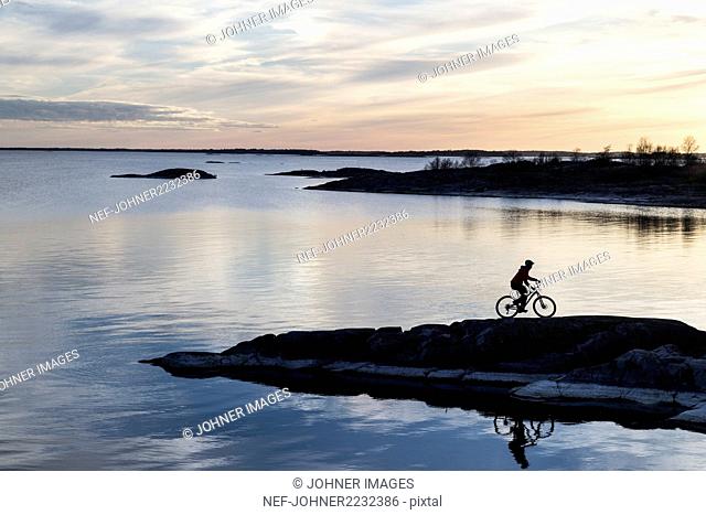 Person cycling at sea