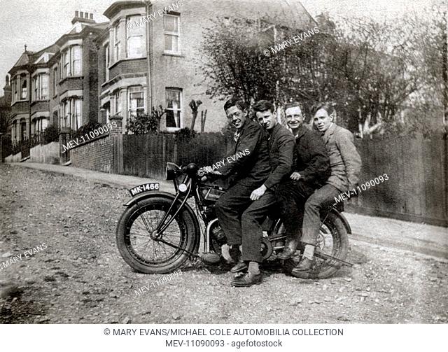 Four men on a 1923 Rudge 500cc ohv motorcycle in unmade road in the 1920s