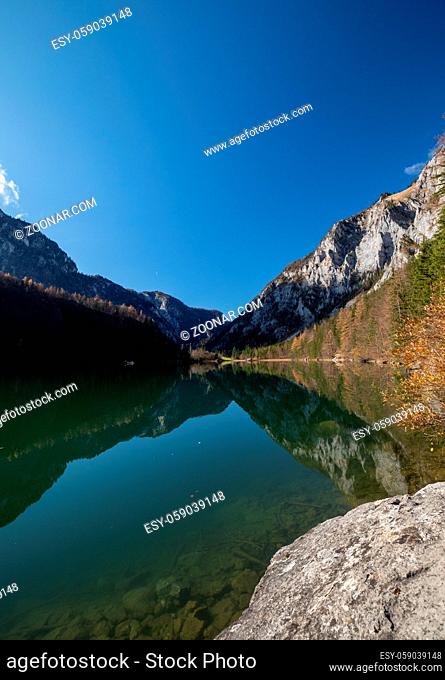 lake and mountain with reflection during autumn in austria - leopoldsteiner lake styria