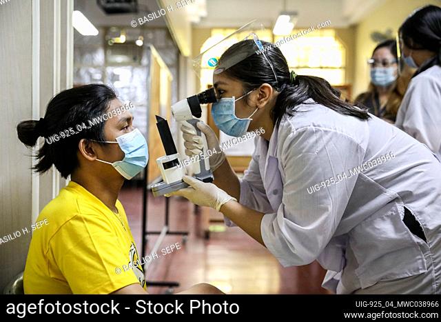 Manila, Philippines. June 10th 2021. Medical students conduct a pupil examination to a standardized patient during a face-to-face class at the University of...