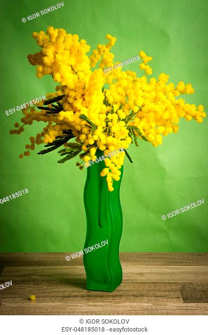 Spring bouquet with mimosa and tulips in a vase