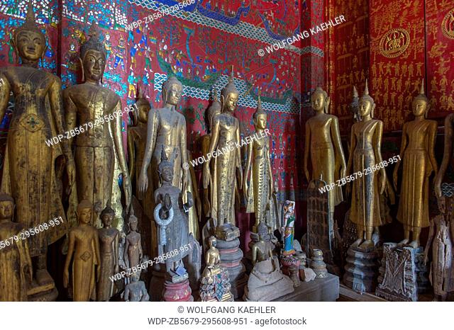 Buddha statues along the wall inside of the Chariot Hall or Royal Funerary Chariot Hall at the Wat Xieng Thong built by King Setthathirath in 1559 in the UNESCO...