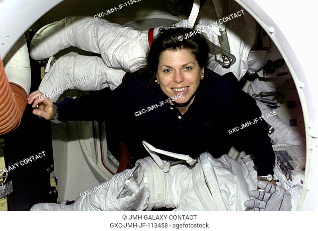 Astronaut Mary Ellen Weber, mission specialist, is surrounded by space suit gear in the airlock of the Space Shuttle Atlantis during early part of the STS-101...